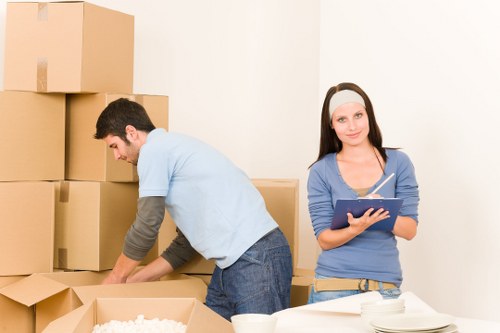Packed boxes and furniture ready for collection by a removal company